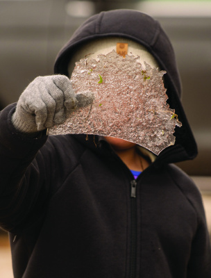 A young child enjoys the winter weather as they pick up a piece of ice left from the cold weather in Kaufman County over the weekend. Photo courtesy of Anahi Duran