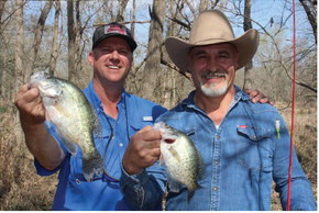 Guide Chris Webb, left, and Kenneth Shepherd show off some nice crappie landed from a backwoods creek recently. Spawning crappie have moved into the creeks above reservoirs and catching should remain good for a few more weeks. Photo by Luke Clayton