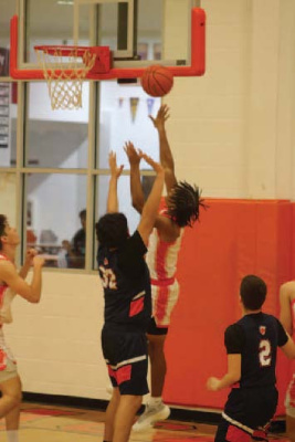 Zaki Brown shoots a basket against David Rodriguez (#32) in Kemp’s home game against Cristo Rey Dallas on November 14th. Photos by Blaine Clamon