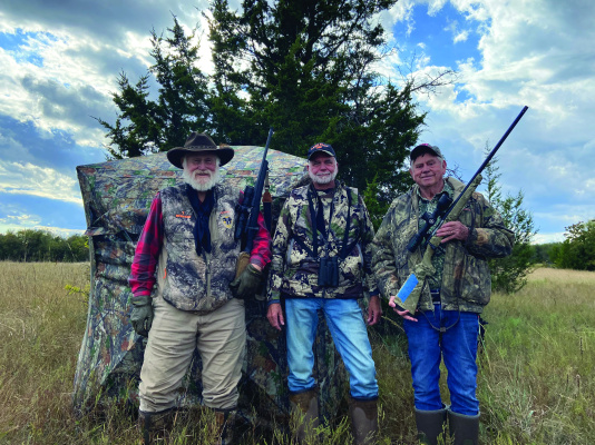 Larry Wieshuhn, Jeff Rice and Luke (left to right) stand in front of a see-through pop-up blind. These blinds have become very popular over the past couple of years. The hunter can see out but game cannot see in. Photo by Don Gresham