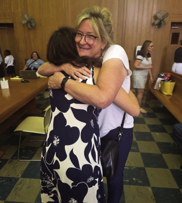 Lilo hugging her CASA Volunteer Irene at her adoption ceremony. Courtesy photo