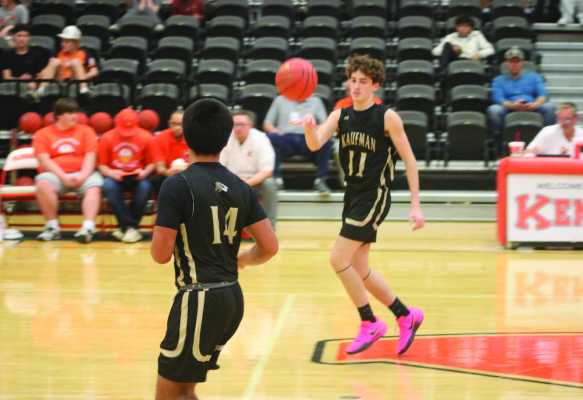 Kaufman Lion Daylon White (#11) passes the ball to Adrian Ordonez (#14) during non-district play between Kaufman and Kemp on Nov. 18. Photo courtesy of Blaine Clamon