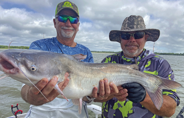 Jeff Rice and Tawakoni catfish guide Tony Pennebaker show off one of many good eating blue catfish landed last week. Photo by Luke Clayton