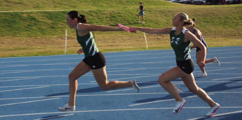 Scurry-Rosser Lady Wildcat Blakely Perkins hands off the baton to Lilly Walker in the 4X100 relay during the District meet. Photo courtesy of James Hill