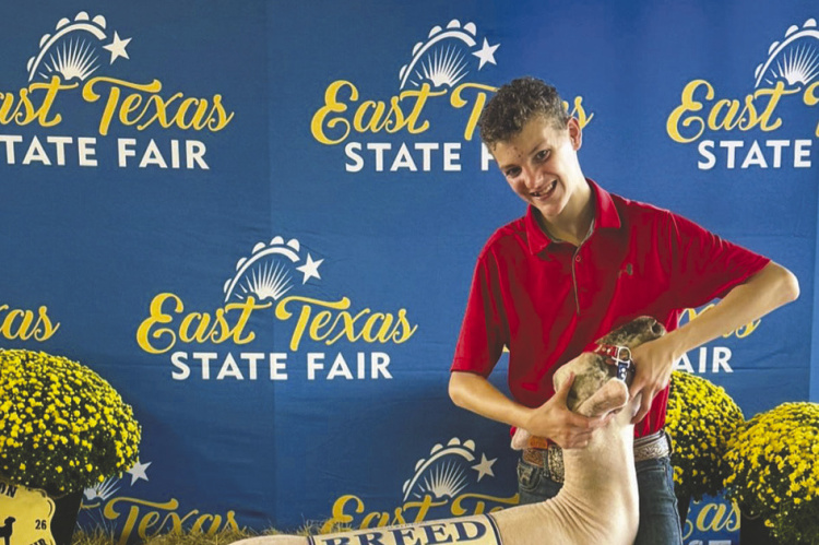 Rowdy Smith joins Kaufman County 4-H students at the Sept. 11-15 East Texas Junior Livestock Show, where he received first place and Fine Wool Cross Breed Champion in the Market Lamb Show, also winning his Southdown class and being named Reserve Breed Champion Southdown. Courtesy Photo/Meagan Smith