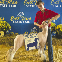 Rowdy Smith joins Kaufman County 4-H students at the Sept. 11-15 East Texas Junior Livestock Show, where he received first place and Fine Wool Cross Breed Champion in the Market Lamb Show, also winning his Southdown class and being named Reserve Breed Champion Southdown. Courtesy Photo/Meagan Smith